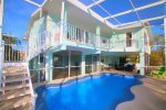 Rest-A-Shore Has a fully screened-in Balcony, Pool and Lanai w/ Seating Areas